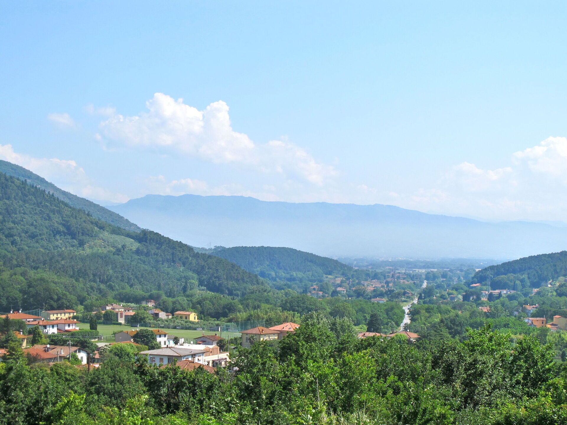 A valley with houses and a river.