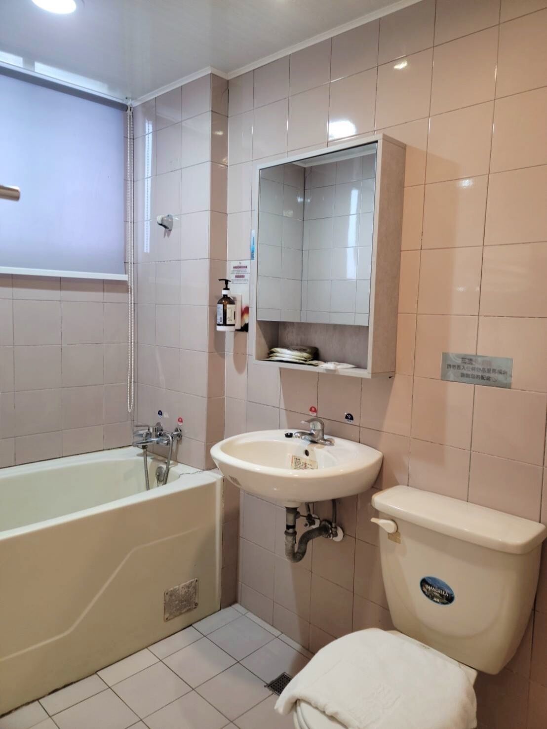 A bathroom with a bathtub, sink, and toilet.