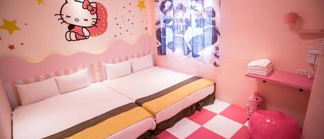 A bedroom with a double bed, a pink chair, a shelf with towels, and a Hello Kitty wall decoration.