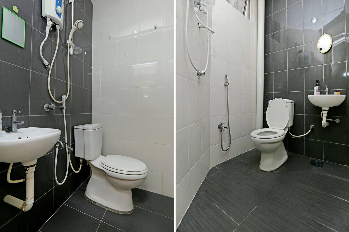 A bathroom with a toilet, sink, and shower.