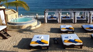 A beachside resort with multiple sunbeds, a hot tub, and a covered seating area. - Soak up sun & fun at a 6-bed villa in the Dominican Republic resort on the ocean (Cofresi)