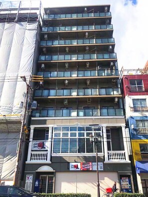 A multi-story building with a series of balconies and large windows. - Hostel Nyoi (Osaka)
