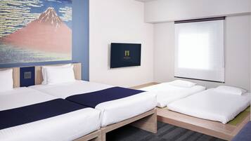A hotel room with two beds, a large painting of a mountain, a framed picture on the wall, and a window with blinds.