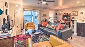 A modern living room with a sofa, coffee table, and a dining area with chairs and a table. - Quiet Home by Dtwn Livingston: Hike, Fish & Ski! (Livingston)