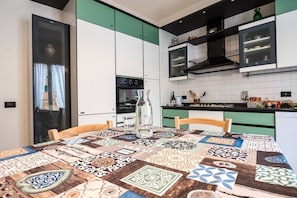 Enjoy cooking in this well-equipped kitchen with oven, microwave, and ample countertop space.