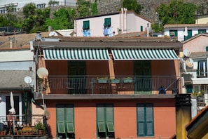 Enjoy the view from the upper-floor balcony with a table and chairs.