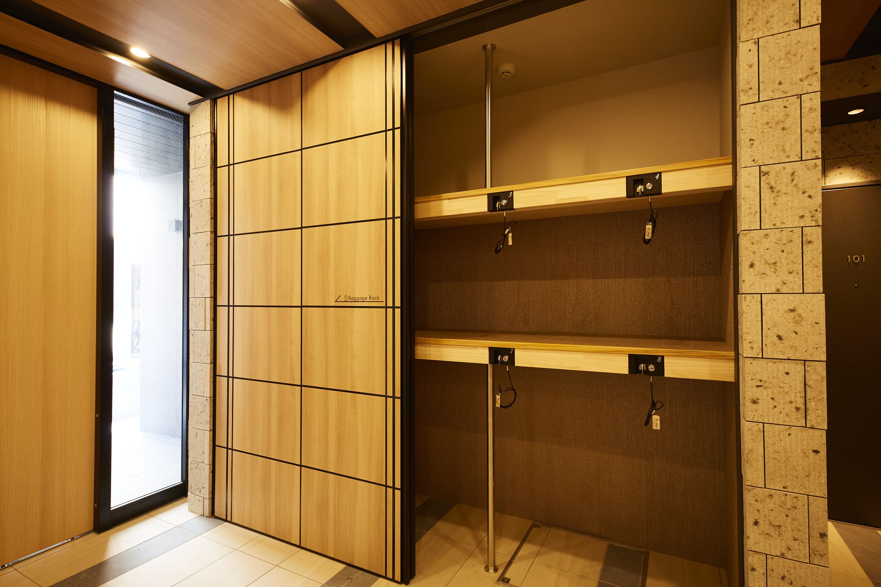 A modern elevator with a wooden panel design, a visible floor number, and a metal handrail.