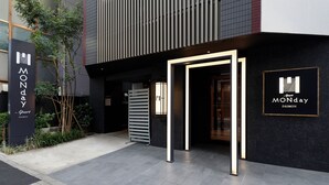 A modern building entrance with a sign for 'Monday Apart' and 'Monday DAIMON.' - MONday Apart Hamamatsucho Daimon (Tokyo)