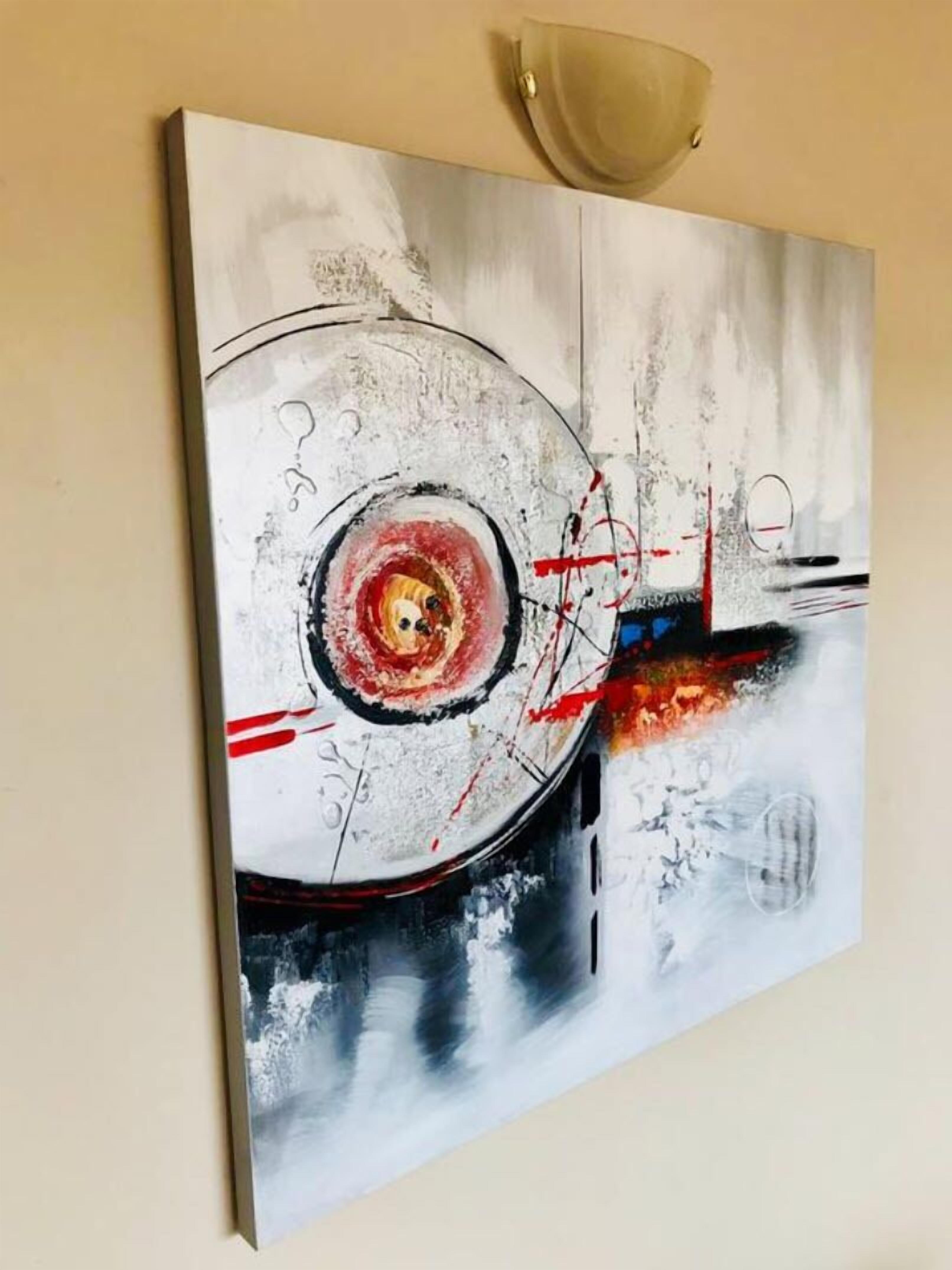 Una pintura con elementos abstractos y un motivo circular.