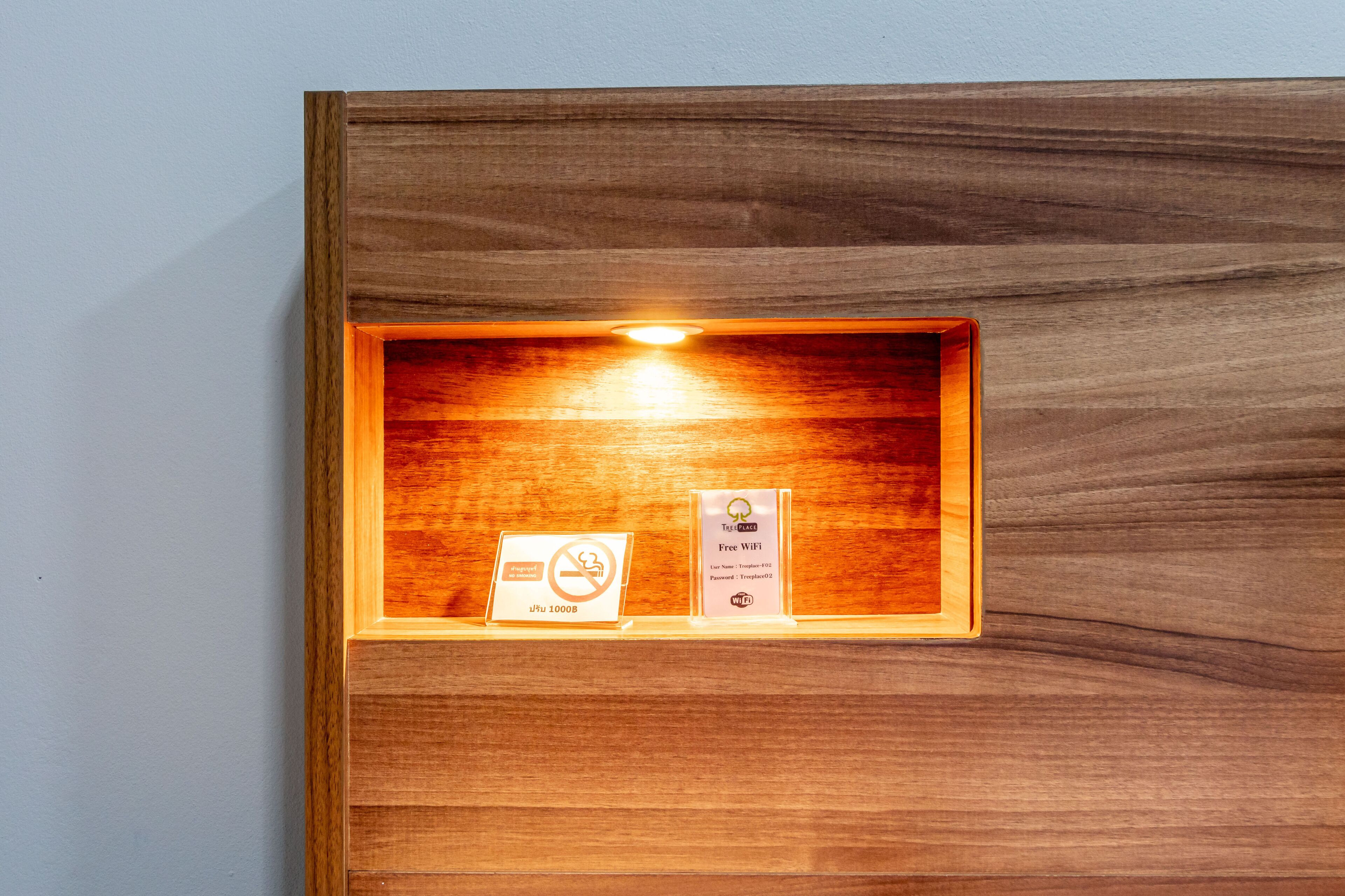 A wooden display case with a sign indicating no smoking and free Wi-Fi access.