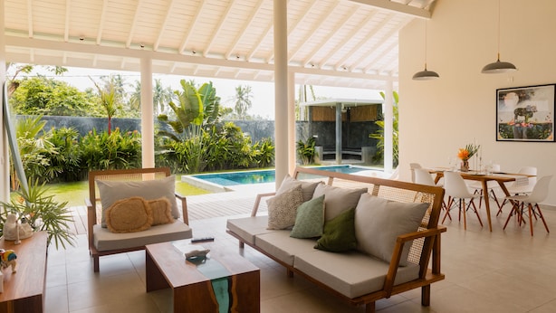 A spacious living area with a pool, outdoor seating, and a dining area. - Good Story Village (Ahangama)
