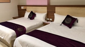 Two double beds with wooden headboards, white bedding, and purple throw pillows. - Yung Cheng (Jinhu)