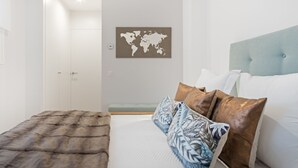 Un dormitorio con una cama, un mapa del mundo en la pared y un plaid de piel.