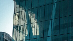 A modern building with large glass windows and a geometric design. - Hotel Filip (Oslo)