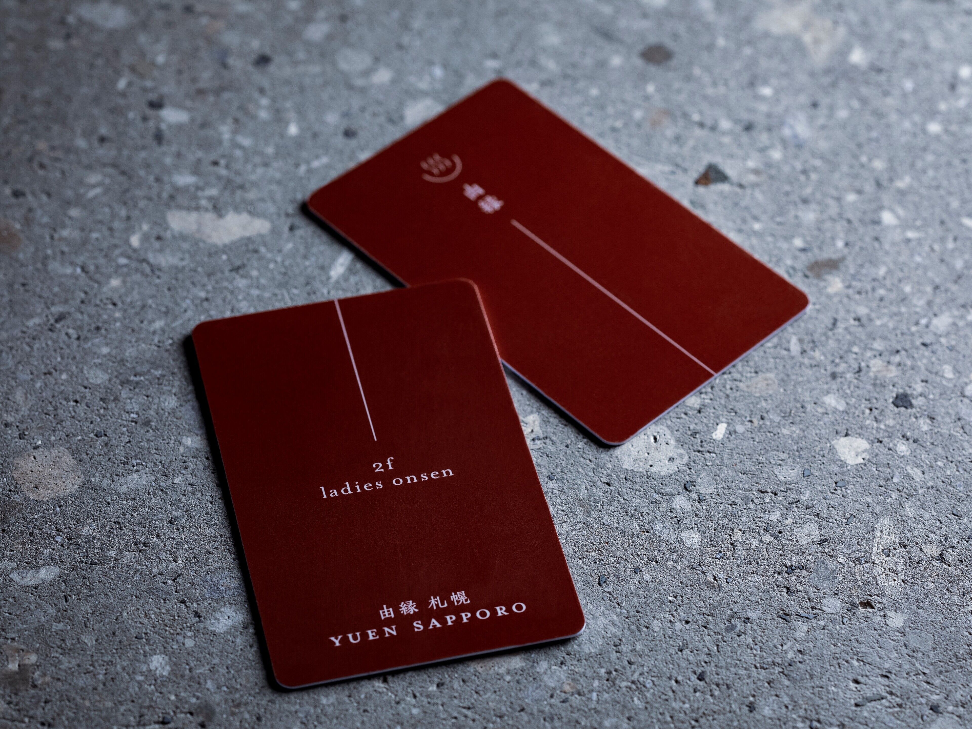 Two red cards with text on a textured surface.
