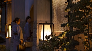 A traditional building with a lantern-lit entrance, stone columns, and a well-maintained garden. - Onsen Ryokan Yuen Sapporo (Sapporo)