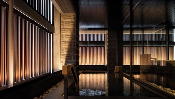 A modern interior with a reflective floor, vertical blinds, and a patterned wall. - Onsen Ryokan Yuen Sapporo (Sapporo)