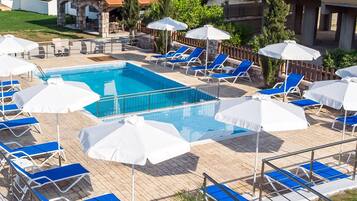 Seasonal outdoor pool, open 10:00 AM to 7:00 PM, pool umbrellas