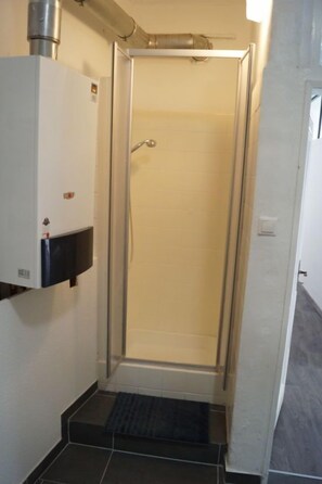 Quadruple Room | Bathroom | Shower, towels, toilet paper
