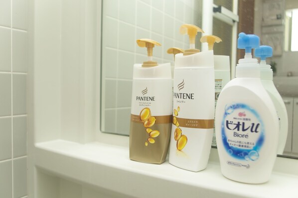Three bottles of Pantene shampoo on a bathroom counter. - Shinsaibashi-House B (Osaka)