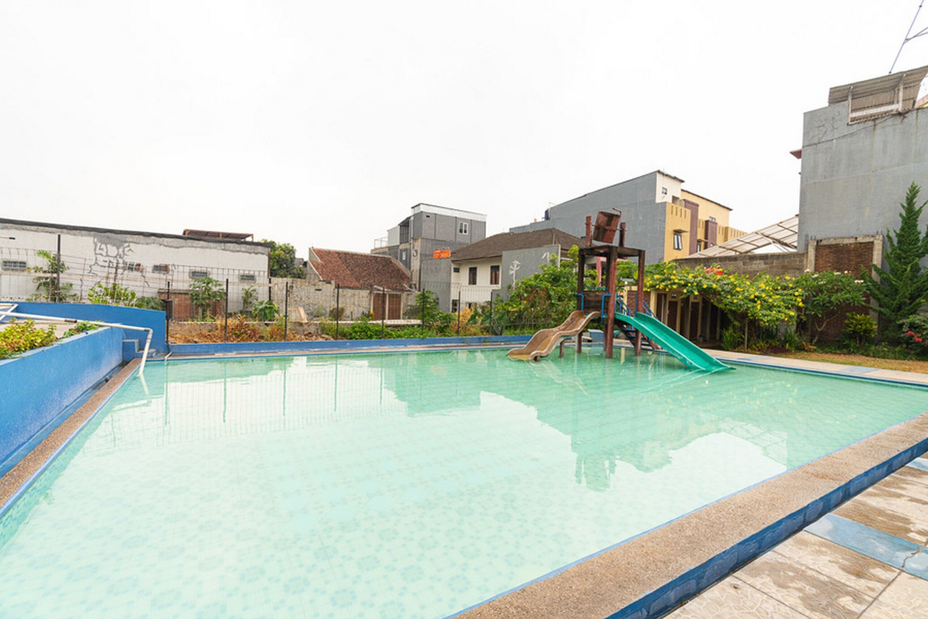 A swimming pool with a slide and a small staircase.