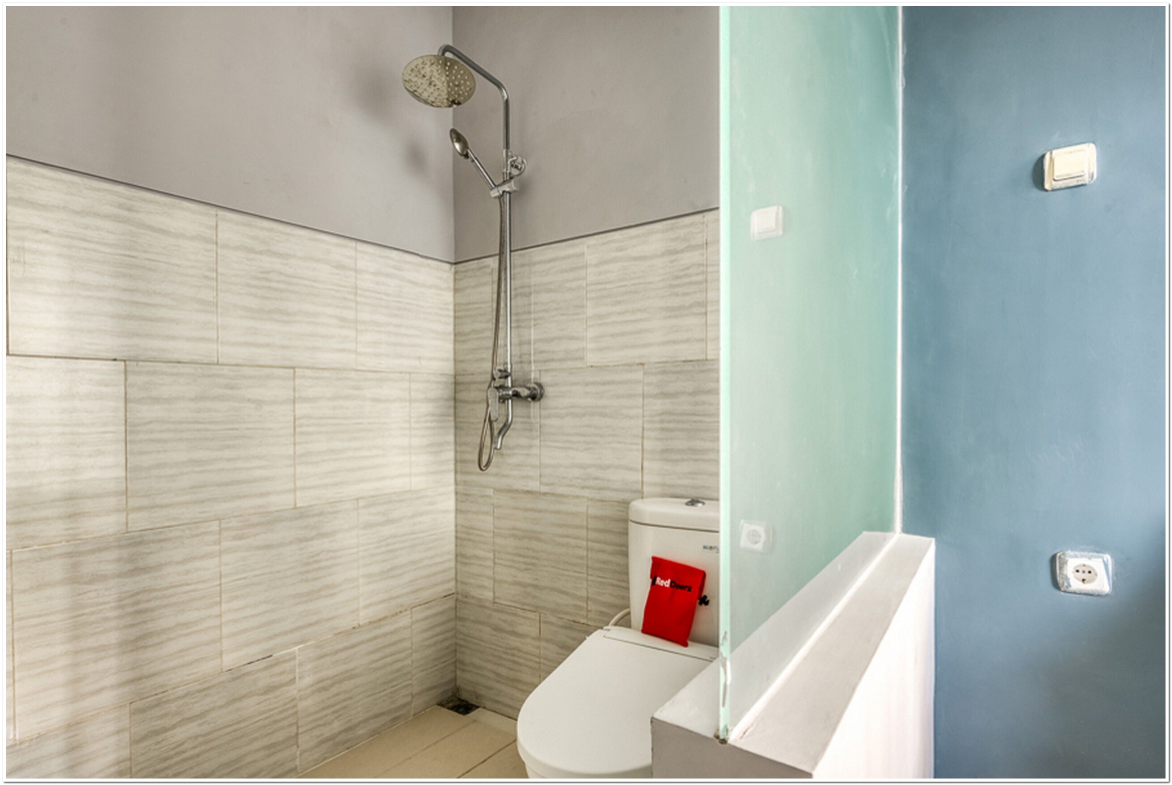 A bathroom with a shower, toilet, and sink.