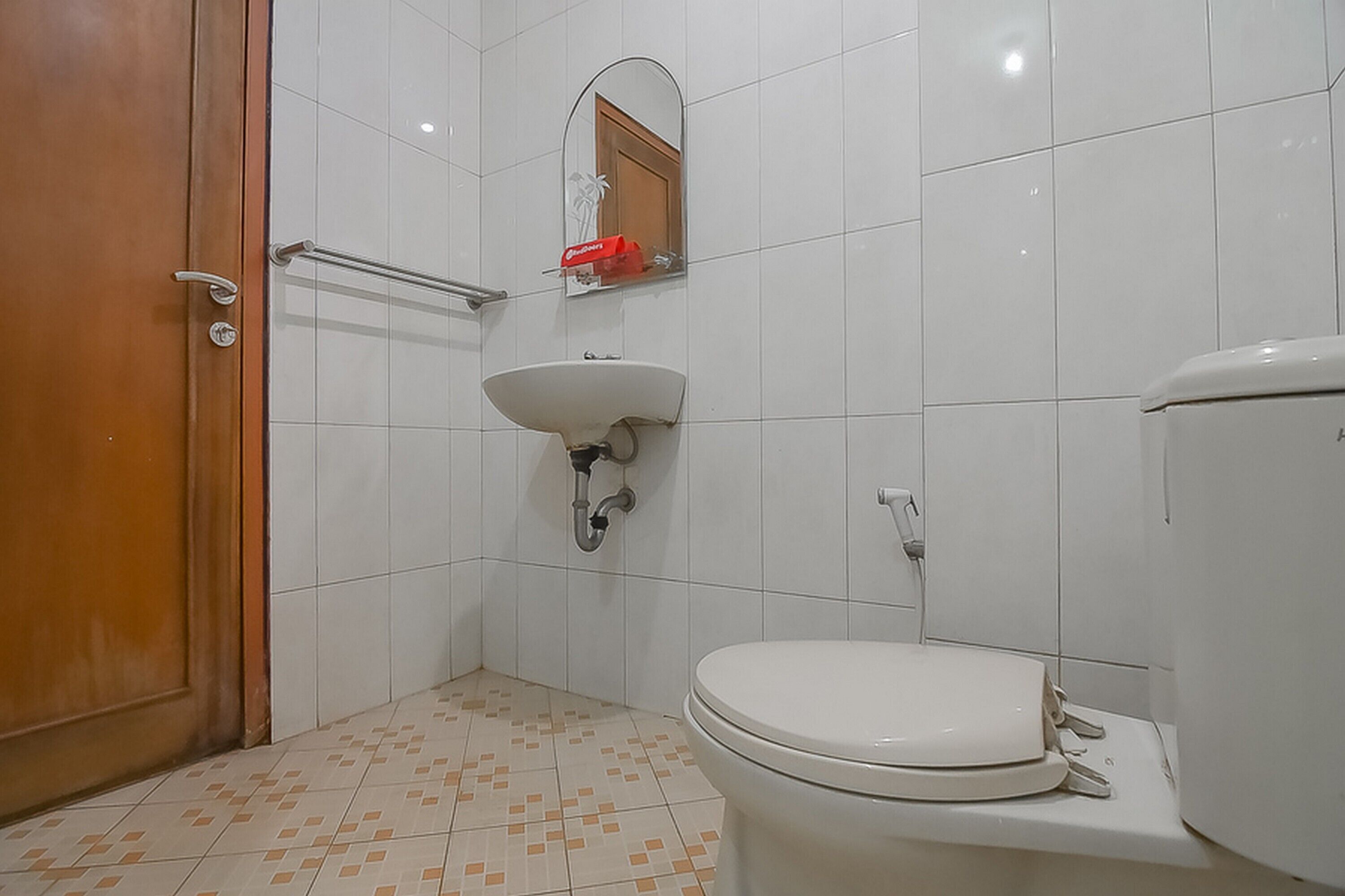 Une salle de bain avec des toilettes, un lavabo et un miroir.
