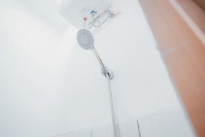 A shower with a handheld showerhead and a wall-mounted control panel. - Formerly Reddoorz Plus @ Otista Raya Ciputat (South Tangerang)