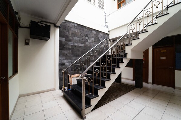 A staircase with metal railings leading to an upper floor. - KoolKost near Padjadjaran University (Bandung)