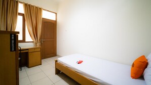 A small, clean room with a single bed, a desk, and a wardrobe. - KoolKost near Padjadjaran University (Bandung)