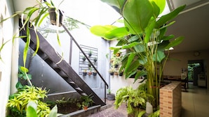 A staircase with potted plants on the sides, leading to an upper level. - KoolKost near BTC Fashion Mall 2 (Bandung)