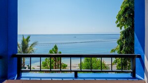 A balcony with a view of the sea and beach. - RedDoorz Plus Syariah @ Hotel Boulevard Luwuk (Luwuk)