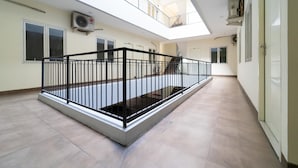 A spacious interior with a central open area, a staircase, and a skylight.