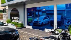 A modern building with a sign reading "DENATIO GUEST HOUSE". - RedDoorz Premium near Centre Point Mall Medan (Medan)