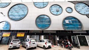 A building with large circular windows and a sign for 'BGB PT. BAMBANG DJAJA'. - RedDoorz Plus @ Centrium Katamso Medan (Medan)