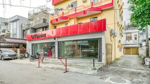 A building with a red storefront labeled "DeCamenz."