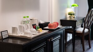 A hotel room with a breakfast tray, a television, a lamp, and a chair. - My Gallery Boutique Hotel & Spa (Sa Pa)
