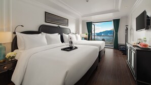 A hotel room with two beds, a TV, and a view of mountains. - My Gallery Boutique Hotel & Spa (Sa Pa)