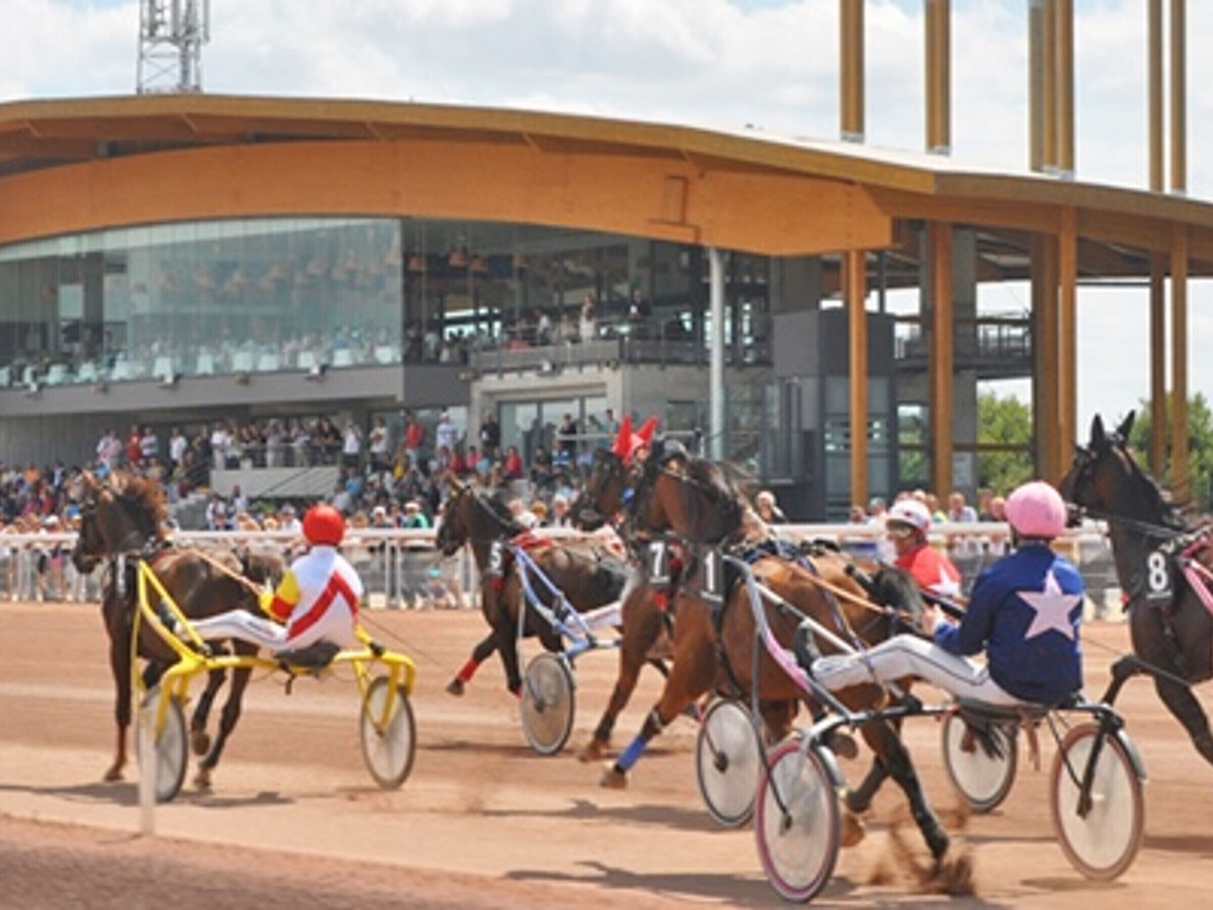 A horse race with jockeys on bicycles.