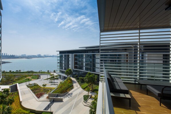 A modern building with a view of a body of water and a city skyline.