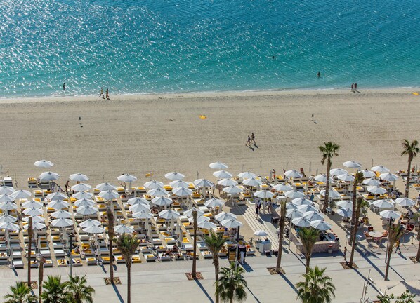Private beach, white sand, sun loungers, beach umbrellas