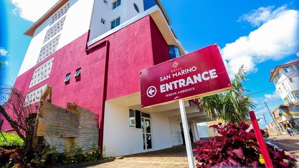 The entrance to the San Marino Hotel with a clear sign indicating the location. - Hotel San Marino (Kitui)