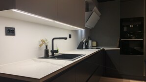 Deluxe Apartment | Private kitchen | Coffee/tea maker, fridge, microwave, oven - Arctic Homes (Tromsø)