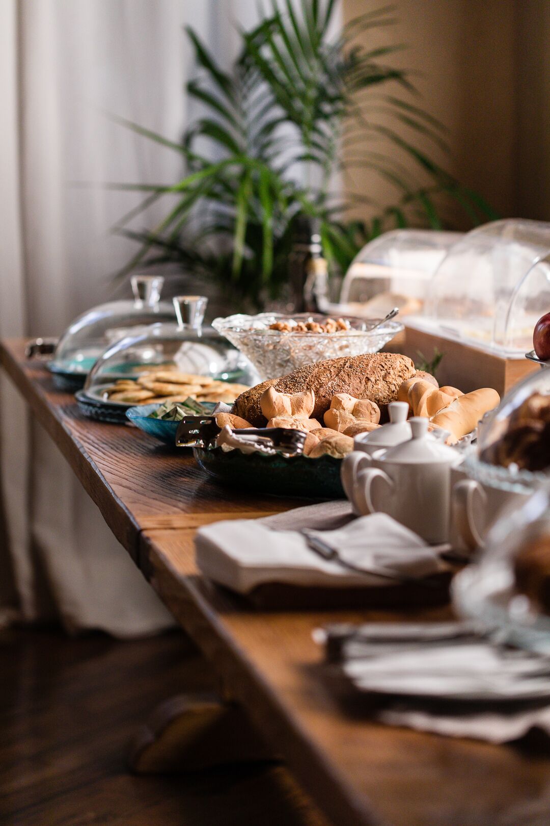 A buffet table with various food items and a coffee pot.
