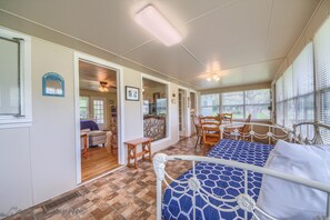 Relax in this inviting room with a large bed, dining table, and framed artwork.