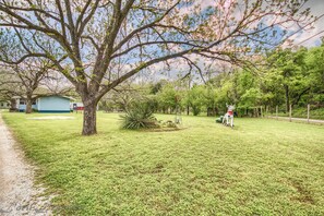 Surrounded by a well-maintained lawn and a large tree, this home offers a peaceful living environment.