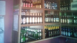 A bar area with shelves stocked with various beverages, including bottles and cans. - Rama Restaurant (Nairobi)