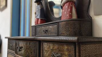 A vintage wooden dresser with intricate carvings and a mirror.