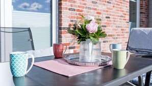 Ein Tisch mit Tablett, einer Blumenvase und drei Tassen.