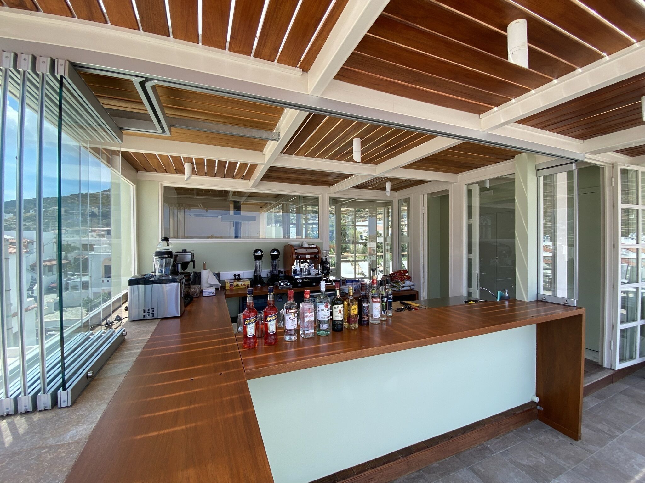 A modern kitchen with a wooden countertop and various appliances.